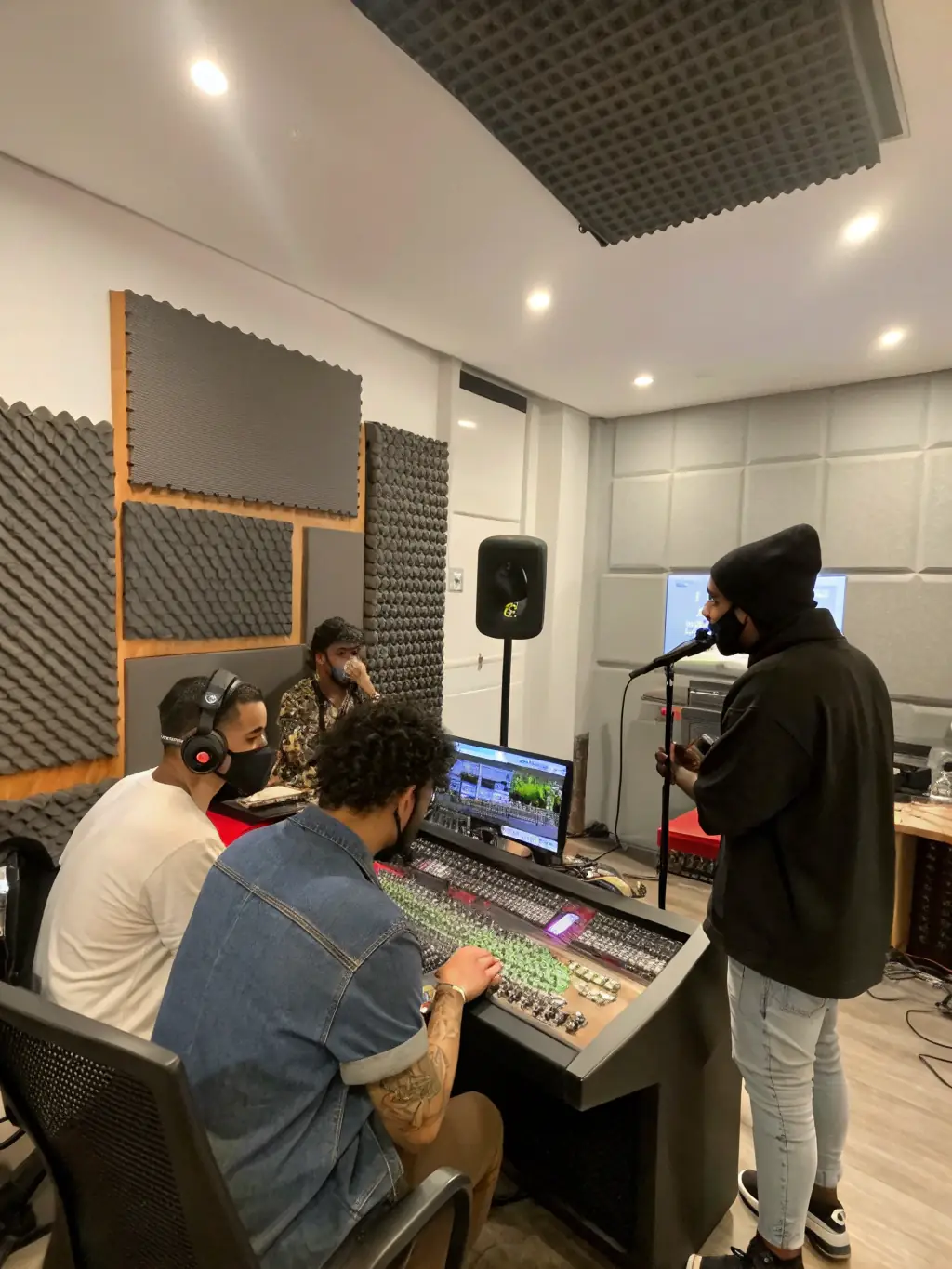 A focused shot of a recording session at a DIMANCHE PROD.-supported studio, highlighting the technical aspects of music production and the creative process.